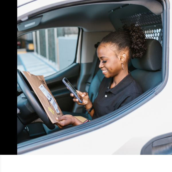 A delivery driver looking at a package.